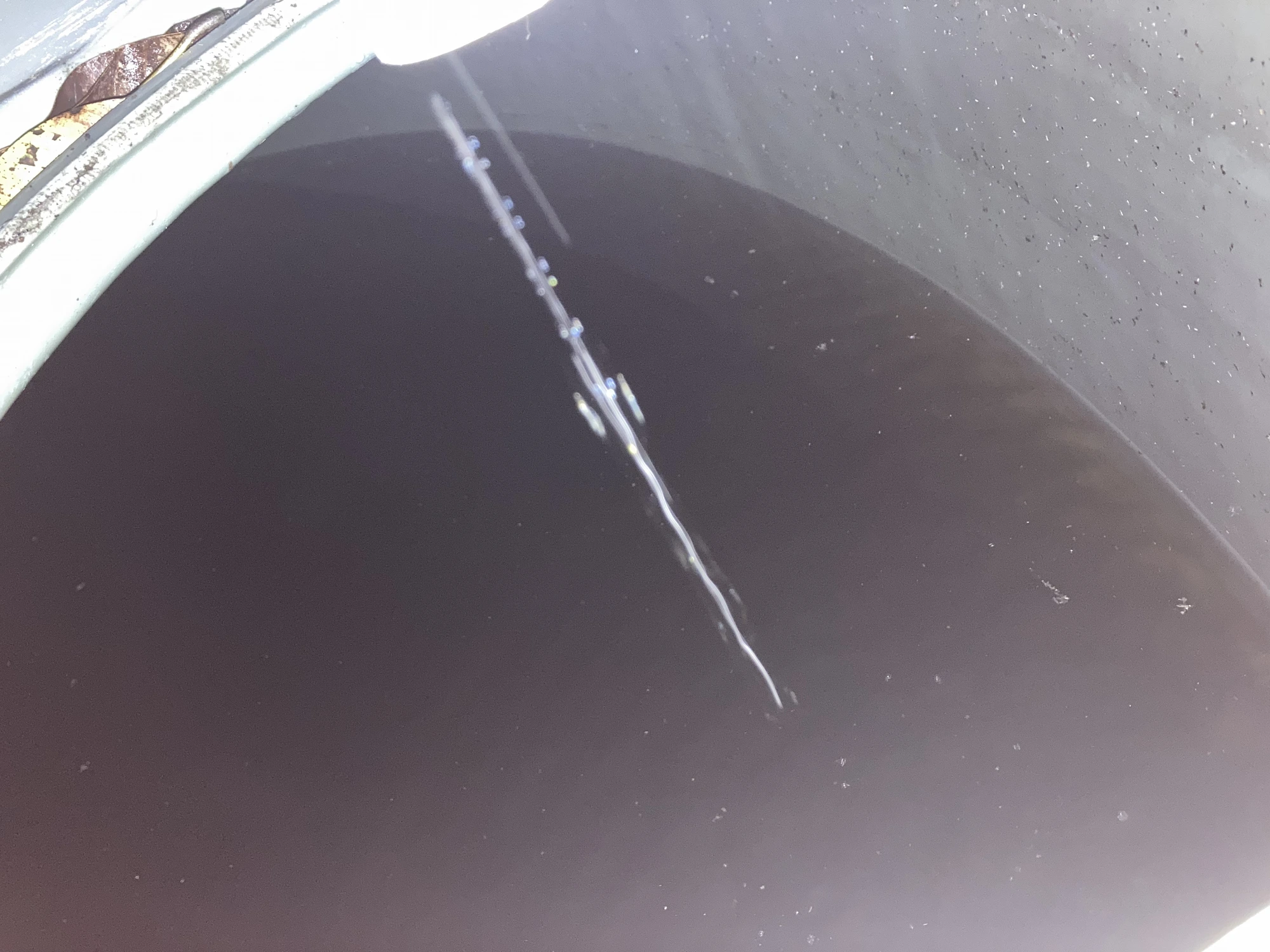 Sediment inside a rainwater tank prior to Pristine QuadClean cleaning